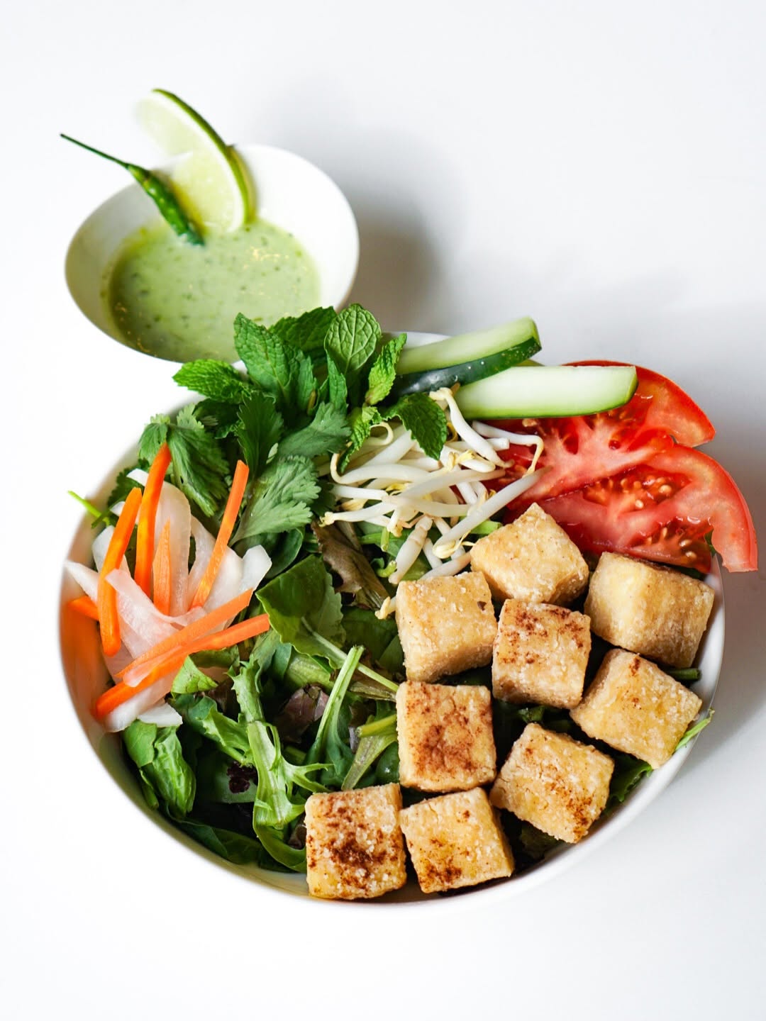 House Salad Bowl with five-spice tofu, greens, tomato and a cup of sesame sauce