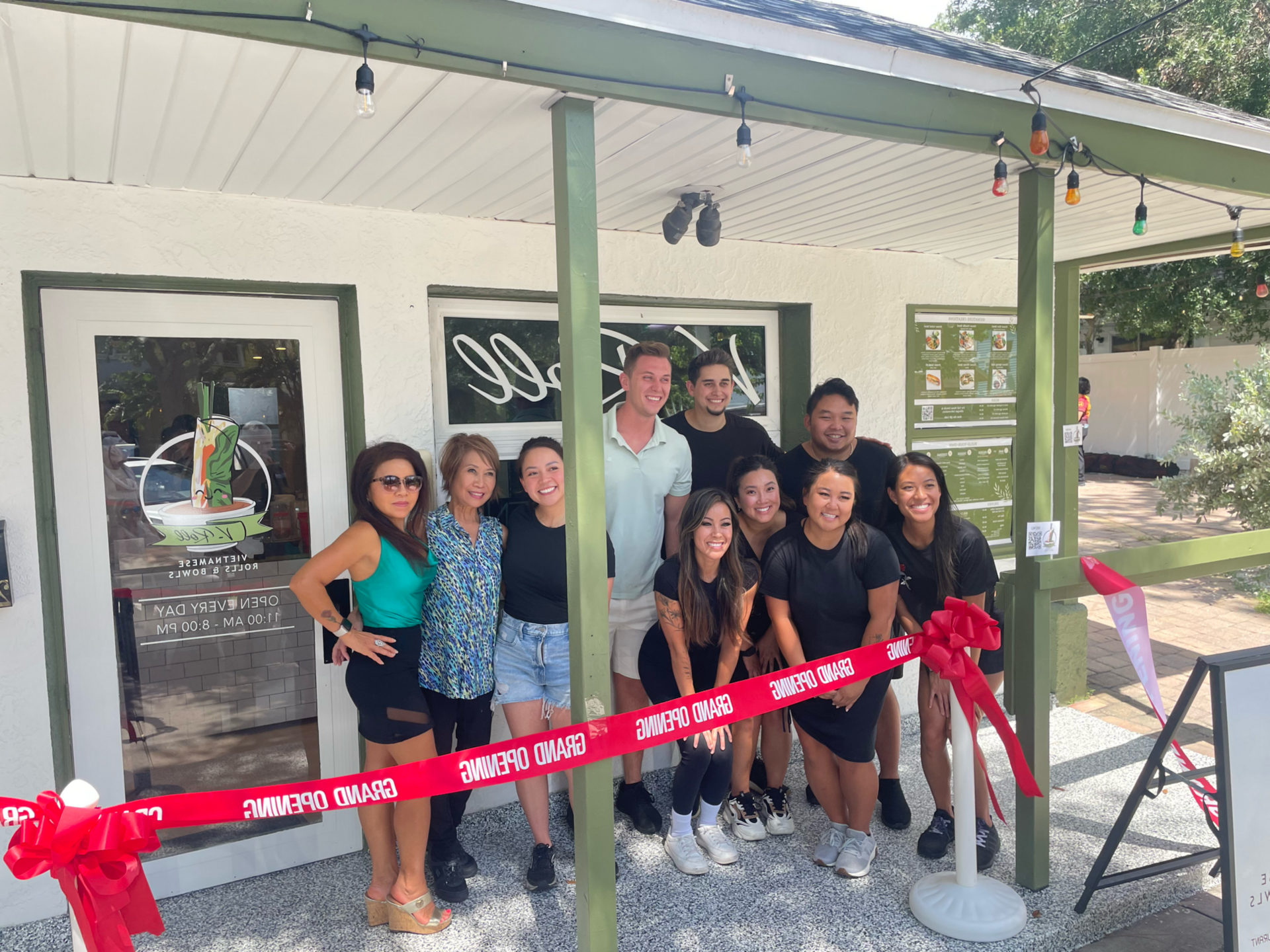 The V-Roll team at the grand-opening ribbon cutting in front of the shop