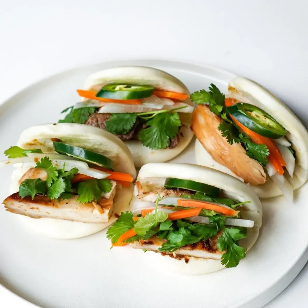 House steam buns (Bao) filled with protein, pickled carrot and cilantro