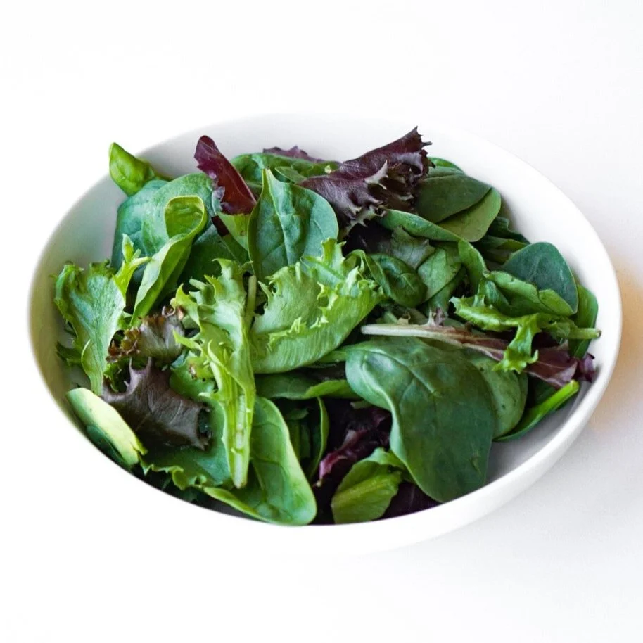 Green leaf lettuce in a white dish, from above