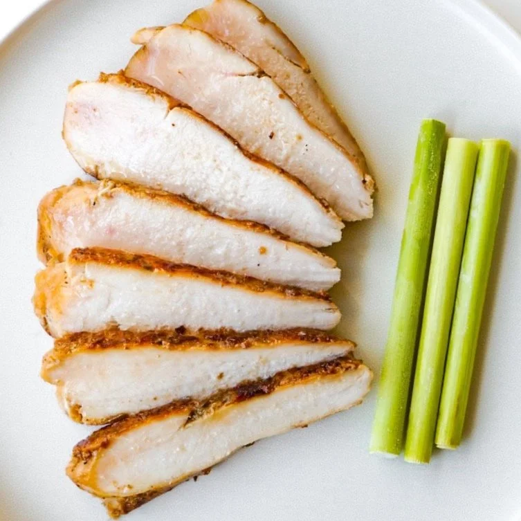 Sliced lemongrass chicken on a white plate