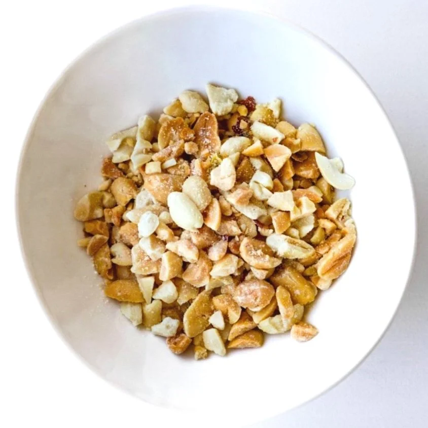 Roasted peanuts in a white dish, from above